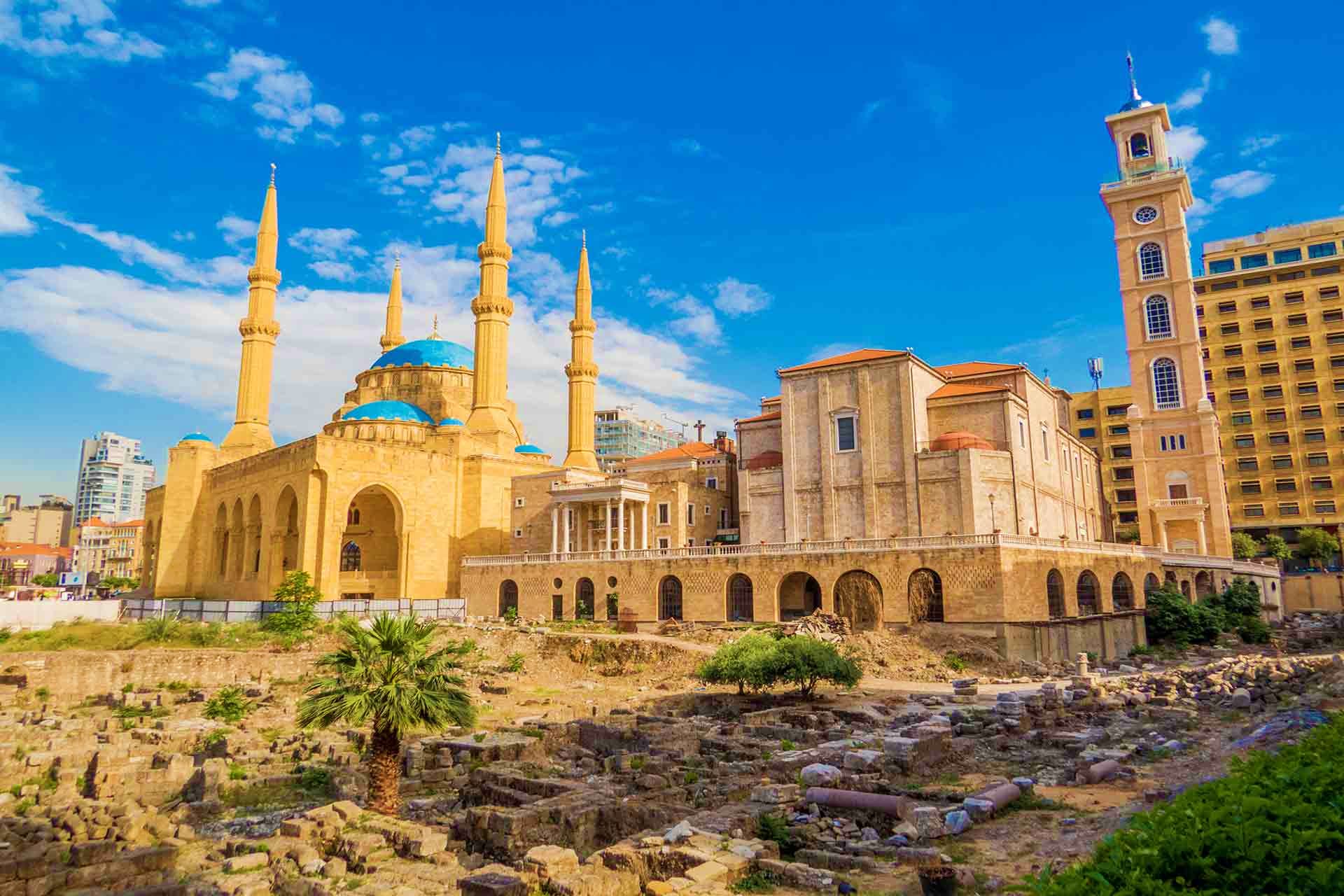 Mohammad Al-Amin Mosque in Beirut, Lebanon with historic ruins and surrounding architecture under clear blue sky